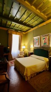 a bedroom with a large bed and a window at Residenza Palazzo Visdomini in Pietrasanta +40 photos