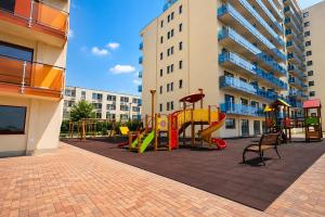 a playground in front of a apartment building at Red Hotel Accommodation in Cluj-Napoca