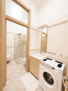 a bathroom with a washing machine and a sink at Palazzo Degli Affreschi - Luxury Villa Verona in Verona