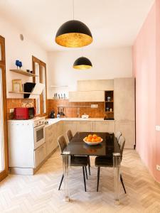 a kitchen with a table and chairs in a room at Palazzo Degli Affreschi - Luxury Villa Verona in Verona