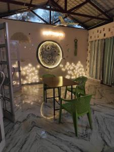 a table and two chairs in a room at The Doghouse in Dehradun