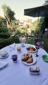 a white table with plates of food on it at Residenza Palazzo Visdomini in Pietrasanta