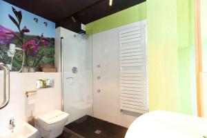 a bathroom with a white toilet and a sink at Grupo Izarbe, HOTEL ELLAURI in Zeanuri +26 photos