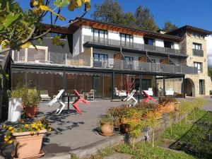 a house with a lot of plants in front of it at Grupo Izarbe, HOTEL ELLAURI in Zeanuri