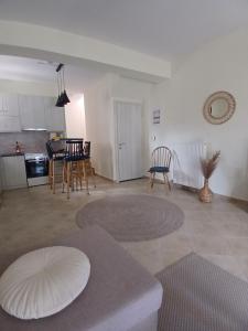 a living room with a table and a kitchen at Vytina maisonette in Vitina