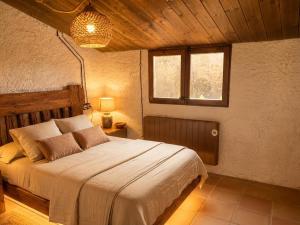 a bedroom with a large bed in a room at Cal Catiu in Caserras +15 photos
