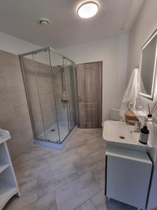a bathroom with a shower and a sink at Karlskovhuset in Give +16 photos