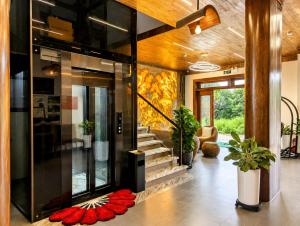 a lobby with a glass door with red flowers on the floor at Daisy's Villa TamCoc in Ninh Binh
