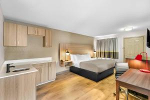 a hotel room with a bed and a table at Quality Inn in Helen +96 photos