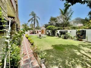 a yard of a house with a lawn at Signature 3 Bed Villa Clifton Boat Basin in Karachi