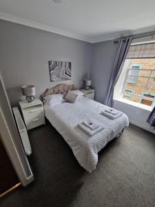 a bedroom with a large bed and a window at The Coastal Inn OUTBUILDING in Cellardyke