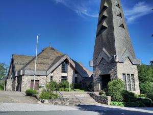 a church with a tall tower in front of it at Herbergskirche Gleidorf in Schmallenberg +2 photos