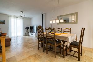 a dining room with a table and chairs at Le Beauregard - Piscine in Beauregard-Baret