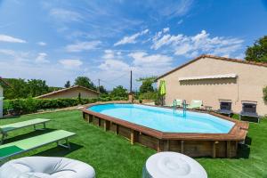 a swimming pool in a yard next to a house at Le Beauregard - Piscine in Beauregard-Baret