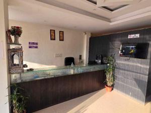 a restaurant with a bar with plants in a room at Collection O Parsi Point Mahabaleshwar Formerly Jungle Eye in Mahabaleshwar