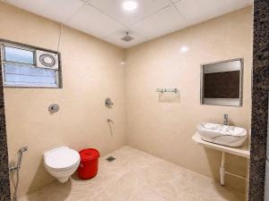 a bathroom with a toilet and a sink at Collection O Parsi Point Mahabaleshwar Formerly Jungle Eye in Mahabaleshwar +25 photos