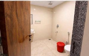 an open door to a bathroom with a toilet and sink at Collection O Parsi Point Mahabaleshwar Formerly Jungle Eye in Mahabaleshwar