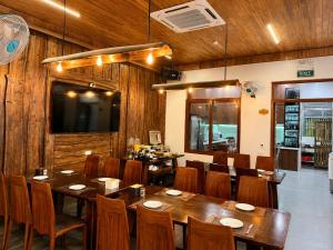 a dining room with a large table and chairs at Daisy's Villa TamCoc in Ninh Binh