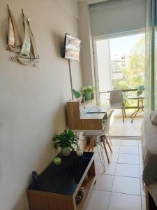 a room with a desk and a bed and a balcony at Studio Nicki Chania in Chania
