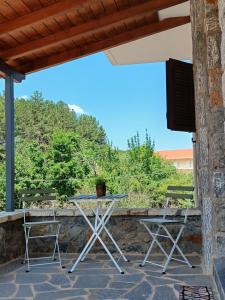 a table and two chairs on a patio at Vytina maisonette in Vitina