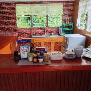 a kitchen with a counter with food on it at Pelly Homestay Adventure in Taveuni +17 photos