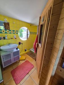 a yellow bathroom with a sink and a mirror at Saat der Hoffnung in Wuppertal