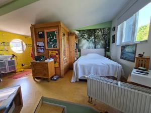 a room with a bedroom with a bed and a sink at Saat der Hoffnung in Wuppertal