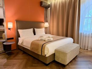a bedroom with a bed with two pillows on it at Ala Boutique Hotel in Almaty +52 photos