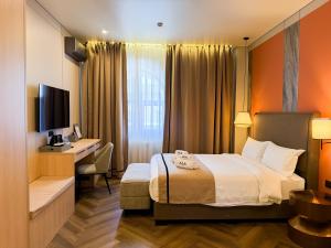 a hotel room with a bed and a desk at Ala Boutique Hotel in Almaty