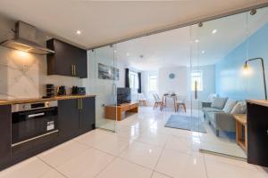 a kitchen and living room with a large glass wall at The Elements Residence in Chepstow +48 photos