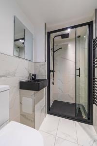 a bathroom with a shower and a sink at The Elements Residence in Chepstow