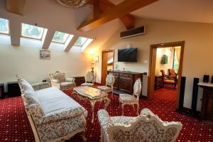 a living room with chairs and a table at Classic Inn Hotel in Braşov
