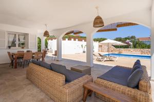 a living room with two couches and a table and a pool at VILLA JESSELLA in Punta Prima +39 photos