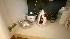 a counter top with a tea pot and a tea kettle at Chez Chagall cozy studio in Sarlat-la-Canéda