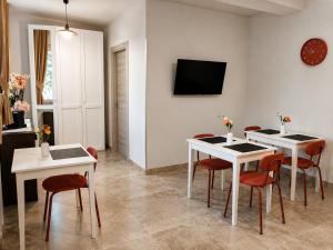 a dining room with white tables and red chairs at B&B da Cencia in Monte San Biagio