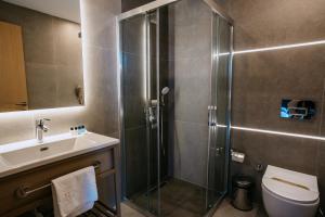 a bathroom with a shower and a toilet and a sink at Perast City Hotel in Antalya +35 photos