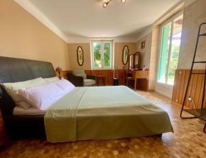 a bedroom with a large bed and a living room at Chez Chagall cozy studio in Sarlat-la-Canéda +36 photos