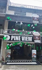 a ping view sign on the front of a building at Pine View Hotel in Abbottabad
