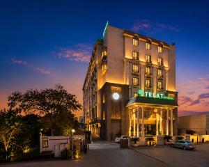 a hotel building with a sign on it at night at Treat Imperial Aurangabad City Center in Aurangabad