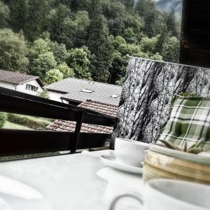 a table with a plate of food on a balcony at Hofwiese in Hohenschwangau