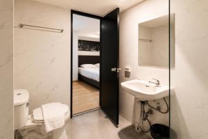 a bathroom with a sink and a toilet at The Blocks Hostel Sukhumvit 10 in Bangkok