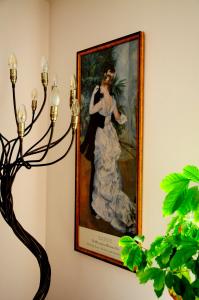 a painting of a woman in a white dress on a wall at Hofwiese in Hohenschwangau