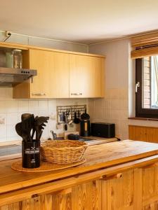 a kitchen with a counter with a basket on it at Waldzauber am See in Clausthal-Zellerfeld +12 photos