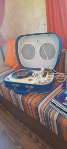 a suitcase sitting on top of a bed at Chez Flo&Fred Caravane Vintage in Barbery