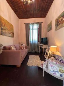 a living room with a couch and a table at The Stone House in Maronia