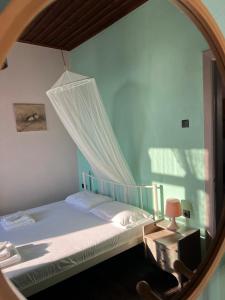 a bedroom with a bed and a mirror at The Stone House in Maronia