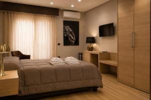 a bedroom with a bed with towels on it at ALMA ROOM in Santa Maria Capua Vetere