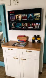 a white counter with movies on the wall at Chalet Como Lake - Nature Retreat, foot access only in Griante Cadenabbia +21 photos