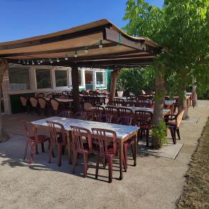a group of tables and chairs under a pavilion at Le Carrefour des Landes in Mimizan-Plage