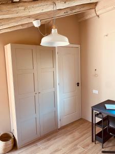 a room with a white closet and a wooden ceiling at Buhardilla con encanto in Ontinyent